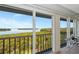 Picturesque water views framed by the screened lanai with sleek railing and table and chairs, perfect for outdoor dining at 1389 Perico Point Cir # 140, Bradenton, FL 34209