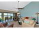 Relaxing living room with comfortable seating, ceiling fan, and water views from the adjacent screened-in lanai at 1389 Perico Point Cir # 140, Bradenton, FL 34209