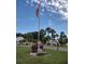 Patriotic common area with American flag and palm trees at 1674 University Pkwy # 389, Sarasota, FL 34243