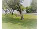 Landscaped common area with mature trees and a park bench at 1674 University Pkwy # 389, Sarasota, FL 34243