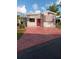 Charming single-story home featuring an inviting red door and striped awnings at 1674 University Pkwy # 389, Sarasota, FL 34243