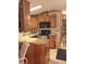 Functional kitchen featuring wooden cabinets, granite countertops and modern appliances at 1674 University Pkwy # 389, Sarasota, FL 34243