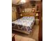 Inviting bedroom featuring a comfortable bed, wood paneled walls and soft lighting at 1674 University Pkwy # 389, Sarasota, FL 34243