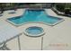 Large swimming pool and hot tub surrounded by a spacious deck at 1674 University Pkwy # 389, Sarasota, FL 34243