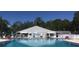 Community pool with lounge chairs and landscaped surroundings at 1674 University Pkwy # 389, Sarasota, FL 34243