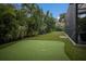 Backyard putting green with lush landscaping and privacy, perfect for leisure and relaxation at 1806 Caribbean Dr, Sarasota, FL 34231