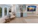 Entertaining bar with light blue cabinets, wine cooler, and wall-mounted liquor storage in this remodeled home at 1806 Caribbean Dr, Sarasota, FL 34231