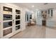Elegant bar area featuring blue cabinets, a wine cooler, and stylish decor, offering a sophisticated space for entertaining at 1806 Caribbean Dr, Sarasota, FL 34231