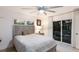 Comfortable bedroom with a ceiling fan, sliding glass doors, and natural light at 1806 Caribbean Dr, Sarasota, FL 34231