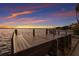 Private dock featuring a bench, providing a serene spot for enjoying waterfront views and sunsets at 1806 Caribbean Dr, Sarasota, FL 34231