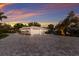 Lovely home with a paver driveway, lush landscaping, and a secure gated entrance for added privacy at 1806 Caribbean Dr, Sarasota, FL 34231