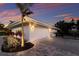 Well-maintained home exterior with a modern garage door, manicured landscaping, and a private gated area at 1806 Caribbean Dr, Sarasota, FL 34231