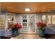 Charming front entrance with wood ceiling, double doors, planters, and neutral tones, creating inviting curb appeal at 1806 Caribbean Dr, Sarasota, FL 34231