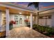 Inviting front entrance featuring double doors, wood ceiling, and lush landscaping, creating a warm, welcoming ambiance at 1806 Caribbean Dr, Sarasota, FL 34231