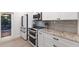 Updated kitchen showcases stainless steel appliances, custom cabinetry, and granite countertops at 1806 Caribbean Dr, Sarasota, FL 34231