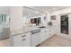 Open-concept kitchen boasts a stainless steel sink, custom cabinets, and a granite countertop at 1806 Caribbean Dr, Sarasota, FL 34231