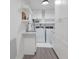 Well-lit laundry room with modern appliances, ample counter space, and storage at 1806 Caribbean Dr, Sarasota, FL 34231