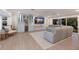 Open-concept living room featuring a gray sofa, a blue bar area, and stylish decor, providing a functional and inviting space at 1806 Caribbean Dr, Sarasota, FL 34231