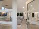 Bright living room with a gray leather sofa, open floor plan, and natural light streaming in through glass doors at 1806 Caribbean Dr, Sarasota, FL 34231