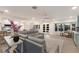 Open-concept living room with a gray leather sofa, hardwood floors, and stylish decor, providing a cozy, and inviting space at 1806 Caribbean Dr, Sarasota, FL 34231