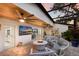 Inviting screened-in patio with a stylish fire pit, comfortable seating, and an entertainment area with a large TV at 1806 Caribbean Dr, Sarasota, FL 34231