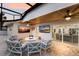 Covered outdoor patio with comfortable seating, tvs and fire pit at 1806 Caribbean Dr, Sarasota, FL 34231