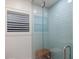 Elegant shower with blue subway tile, a glass door, and updated hardware at 1806 Caribbean Dr, Sarasota, FL 34231