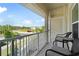 Relaxing balcony with comfortable seating and a view of the surrounding landscape and parking at 200 Gardens Edge Dr # 222, Venice, FL 34285
