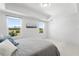Bright bedroom with white walls, modern flooring, large windows with views, and stylish décor at 200 Gardens Edge Dr # 222, Venice, FL 34285
