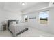 Bright bedroom with white walls, modern flooring, large windows with views, and stylish decor at 200 Gardens Edge Dr # 222, Venice, FL 34285