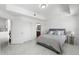 Bright bedroom with white walls, modern flooring, closet, and view to bathroom and kitchen at 200 Gardens Edge Dr # 222, Venice, FL 34285