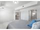 Bright bedroom with white walls, modern flooring, and view to bathroom at 200 Gardens Edge Dr # 222, Venice, FL 34285