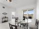 Dining area near an open doorway features a table with seating for four and large window at 200 Gardens Edge Dr # 222, Venice, FL 34285