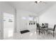Bright dining area with a view to the exterior and open door at 200 Gardens Edge Dr # 222, Venice, FL 34285
