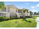 Two-story condo with well-kept lawn and landscaping and a shared stairwell to the units at 200 Gardens Edge Dr # 222, Venice, FL 34285
