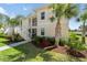 Two-story condo with well-kept lawn and landscaping in front of the building at 200 Gardens Edge Dr # 222, Venice, FL 34285
