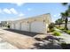 Exterior view of garages in a well-maintained building, with landscaping and a paved driveway at 200 Gardens Edge Dr # 222, Venice, FL 34285