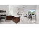 Bright, open kitchen features stainless steel appliances, dark wood cabinets, and quartz countertops at 200 Gardens Edge Dr # 222, Venice, FL 34285