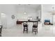 Open-concept kitchen with an eat-in bar, stainless steel appliances, and white subway tile backsplash at 200 Gardens Edge Dr # 222, Venice, FL 34285