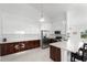 Modern kitchen boasts stainless steel appliances, white cabinets, wood-grain lower cabinets, and tile floors at 200 Gardens Edge Dr # 222, Venice, FL 34285