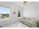 Bright and airy living room with white walls, tile floors, and two windows at 200 Gardens Edge Dr # 222, Venice, FL 34285