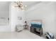 Bright living room area featuring tile flooring, a modern light, and neutral walls at 200 Gardens Edge Dr # 222, Venice, FL 34285