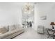 Open-concept living room with views to dining area with bar seating and tile floors at 200 Gardens Edge Dr # 222, Venice, FL 34285