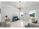 Bright, naturally-lit living room boasts tile floors, neutral paint, and modern ceiling light at 200 Gardens Edge Dr # 222, Venice, FL 34285