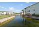 Scenic view of a pond surrounded by lush landscaping and multi-story buildings in a community at 200 Gardens Edge Dr # 222, Venice, FL 34285