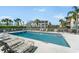 Inviting pool area with plenty of lounge chairs, surrounded by lush landscaping and buildings at 200 Gardens Edge Dr # 222, Venice, FL 34285