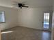 Bright bedroom featuring tile floors, a ceiling fan, a window, and a door to the outside at 210 73Rd Nw St, Bradenton, FL 34209