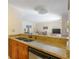 Kitchen featuring granite countertops, light brown cabinets, and stainless steel dishwasher at 2121 Wood St # 221, Sarasota, FL 34237