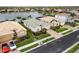 Aerial view of a home with manicured lawn and landscaping on a lake at 2183 Nettlebush Ln, Venice, FL 34292