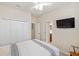 This additional bedroom includes television and closet at 2183 Nettlebush Ln, Venice, FL 34292